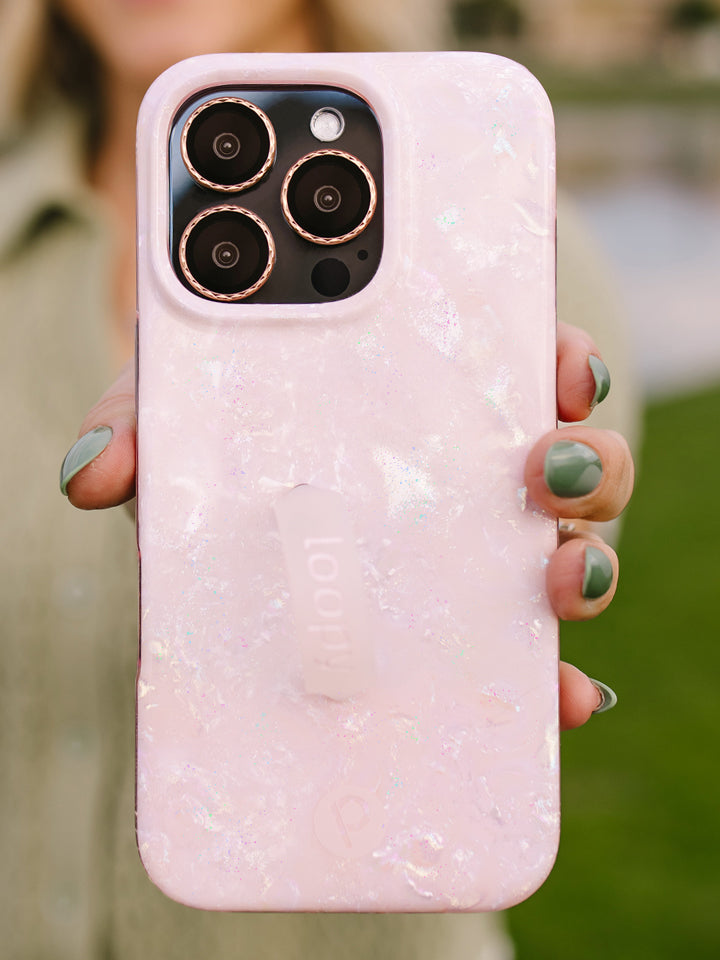 A woman holding a Blush Moonstone Loopy Case. || feature-media