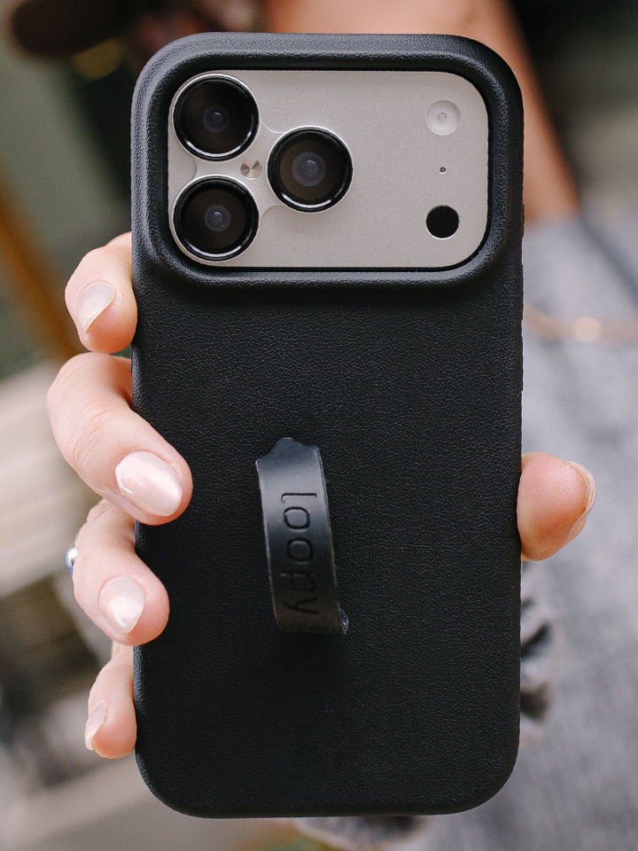 A woman holding an Onyx Loopy Case. || feature-media