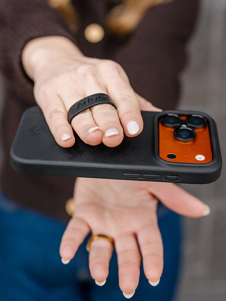 A woman holding an Onyx Loopy Case. || feature-media