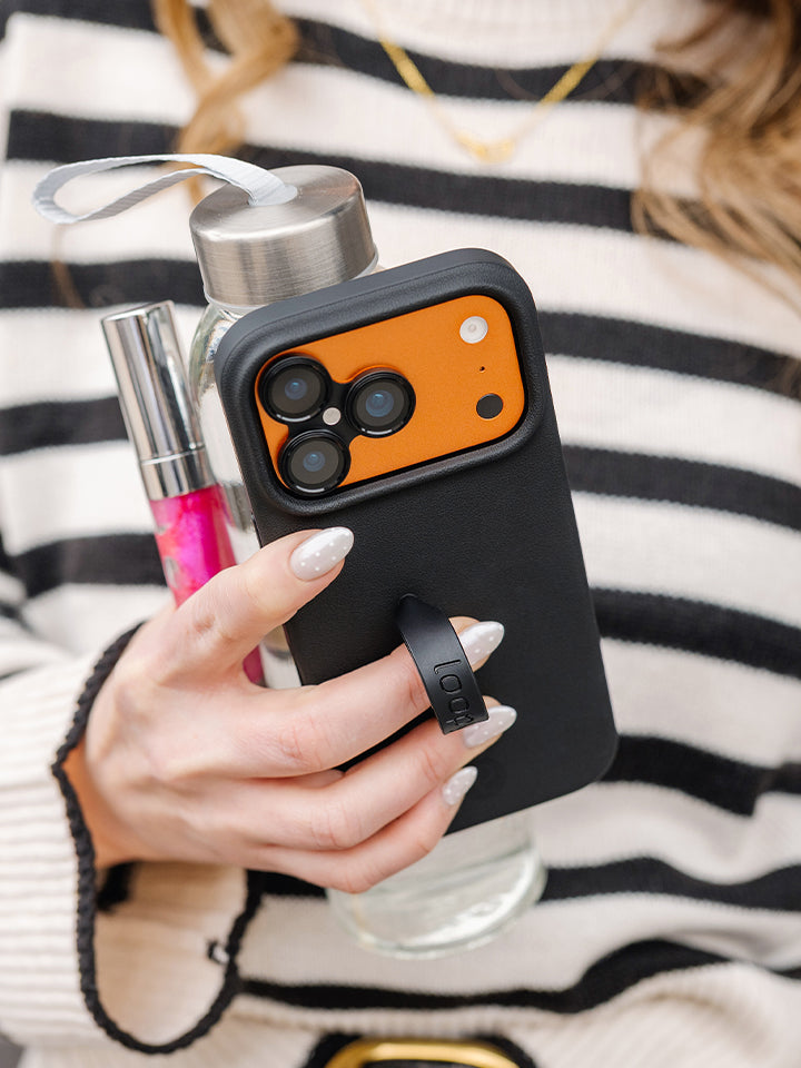 A woman holding an Onyx Loopy Case. || feature-media