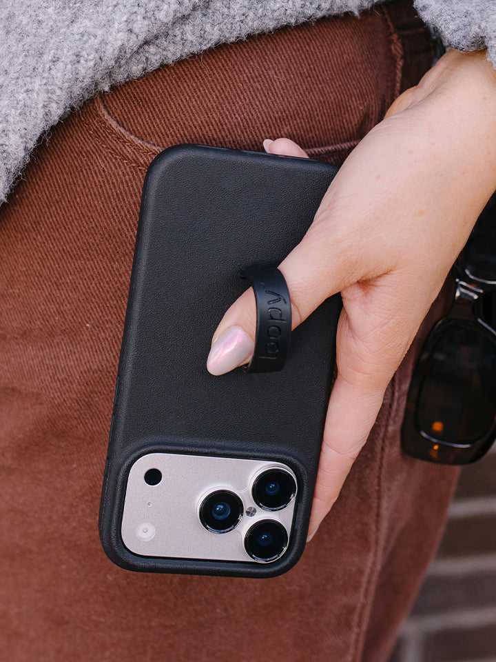 A woman holding an Onyx Loopy Case. || feature-media