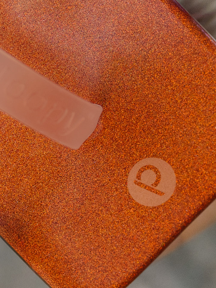 A close up of the shimmer on an Orange Shimmer Loopy Case. || feature-media