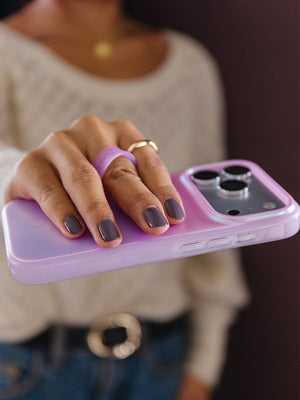 A woman holding a Lavender Pearl Loopy Case. || feature-media