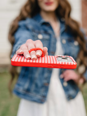 A woman holding a Picnic Check Loopy Case. || feature-media
