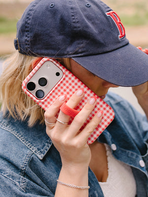 A woman holding a Picnic Check Loopy Case.|| feature-media
