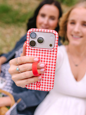 A woman holding a Picnic Check Loopy Case. || feature-media