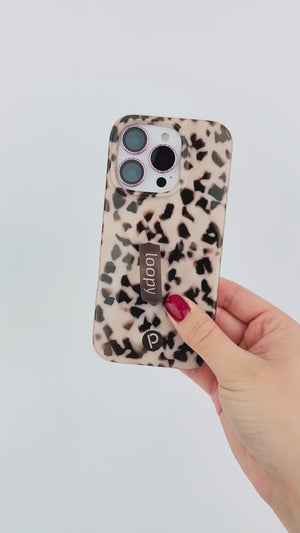 A video of a woman holding a Blonde Tortoise Loopy Case.