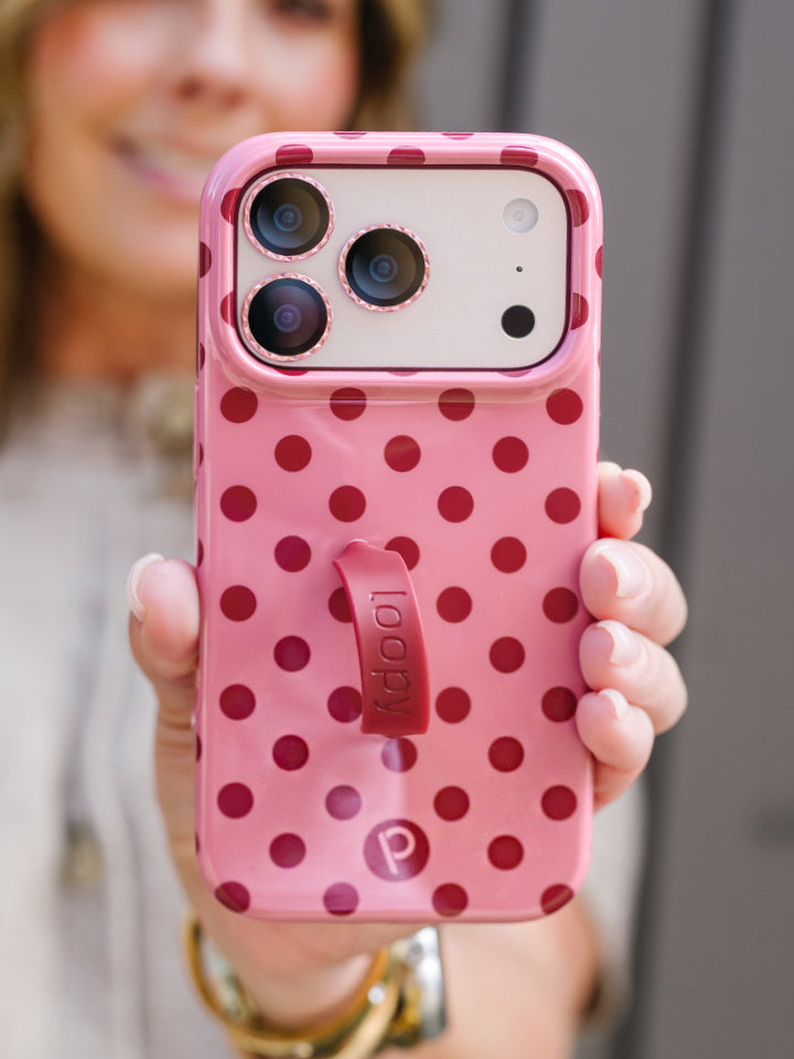 A woman holding a Raspberry Dots Loopy Case. || feature-media