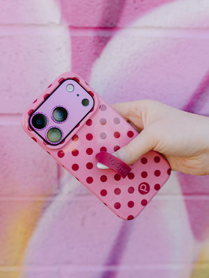 A woman holding a Raspberry Dots Loopy Case. || feature-media