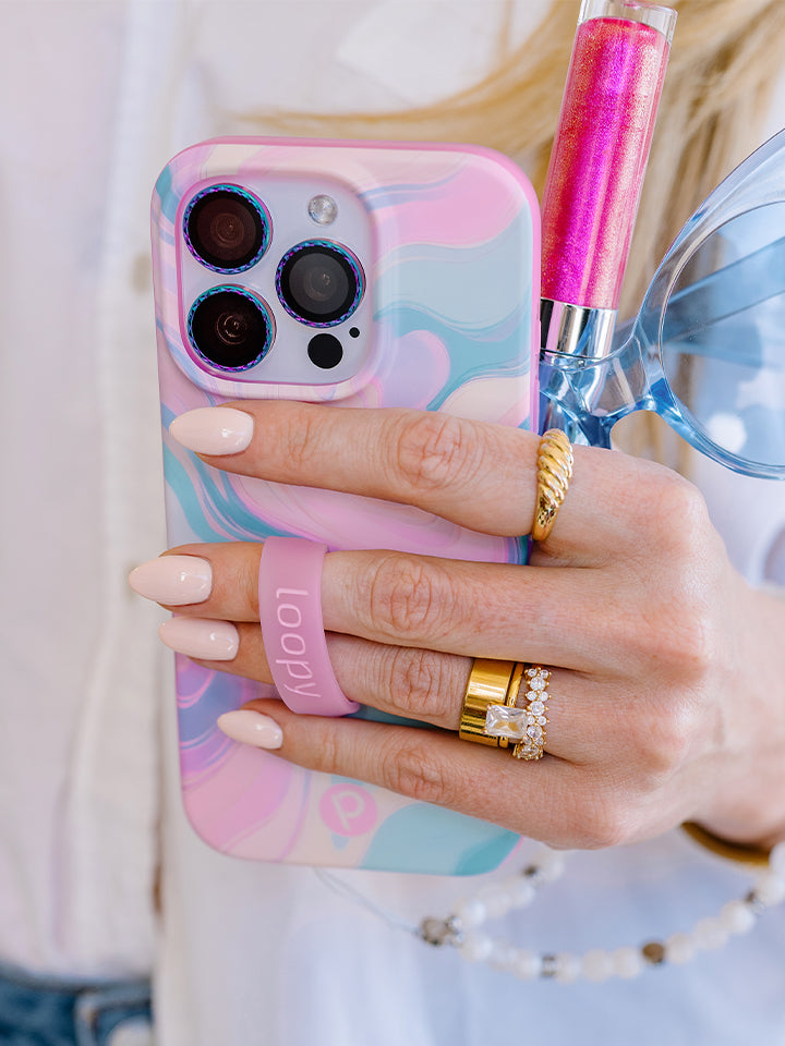 A woman holding a Sherbet Swirl Loopy Case. || feature-media