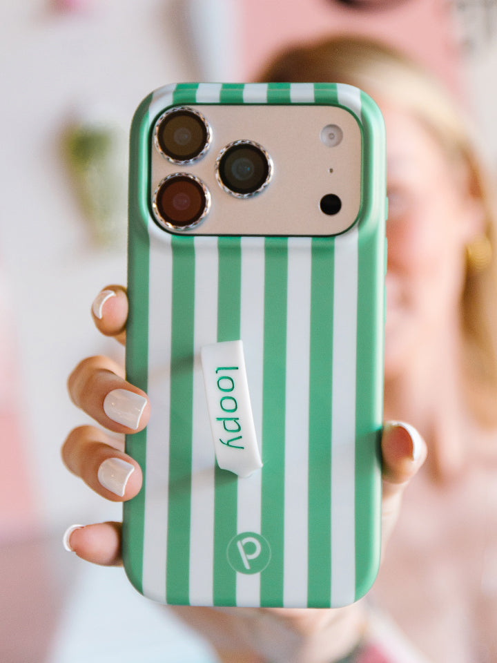 A woman holding a Spearmint Stripes Loopy Case. || feature-media