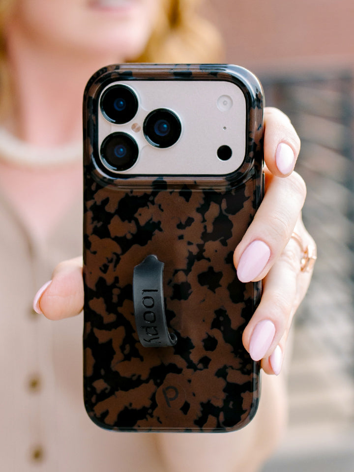 A woman holding a Chocolate Tortoise Loopy Case. || feature-media