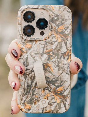 A woman holding a Tree Camo Loopy Case. || feature-media