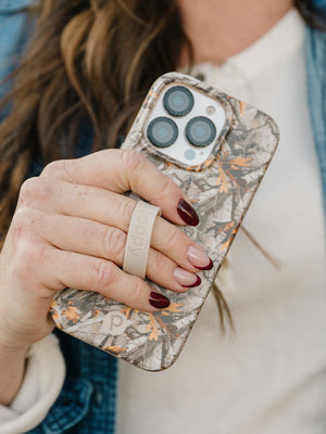 A woman holding a Tree Camo Loopy Case. || feature-media
