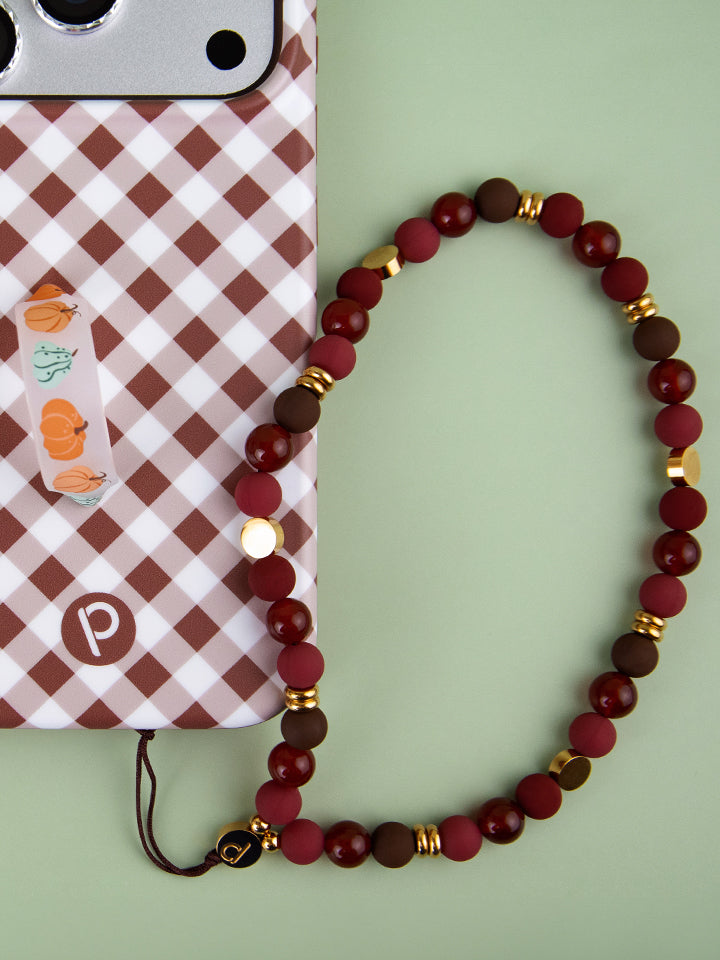 A Cherry Mocha Loopy Cases Wristlet attached to a Brown Gingham Loopy Case.